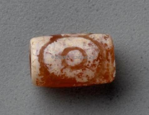 Small etched cylindrical bead of orange carnelian.JPG